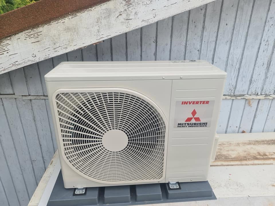 A Mitsubishi Heavy Industries inverter outdoor unit on a deck
